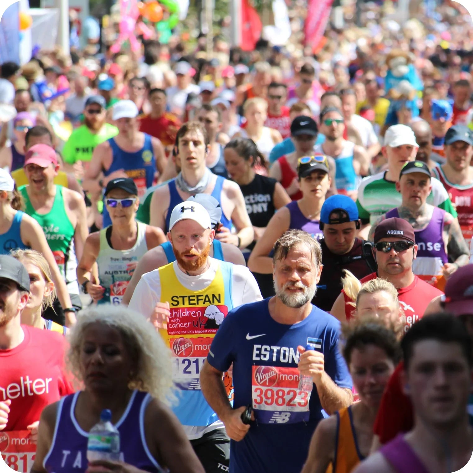 Large group of marathon runners outdoors on a sunny day, hydration and endurance focus