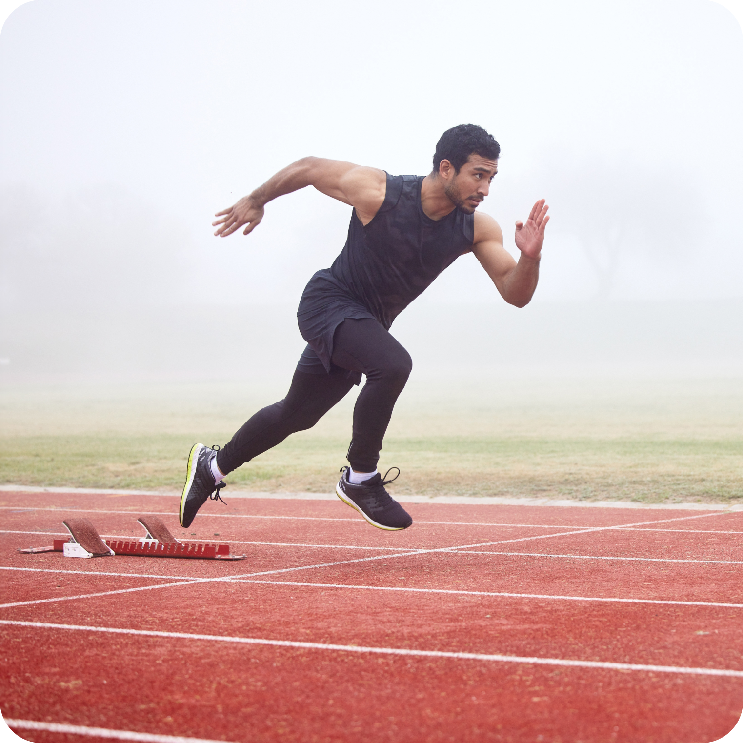 Athlete sprinting on outdoor track, highlighting hydration and electrolytes for performance