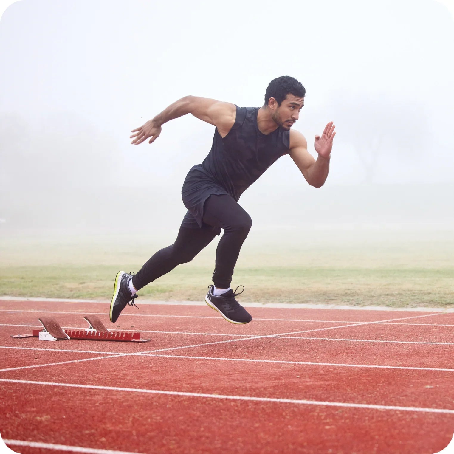 Athlete sprinting on outdoor track, highlighting hydration and electrolytes for performance