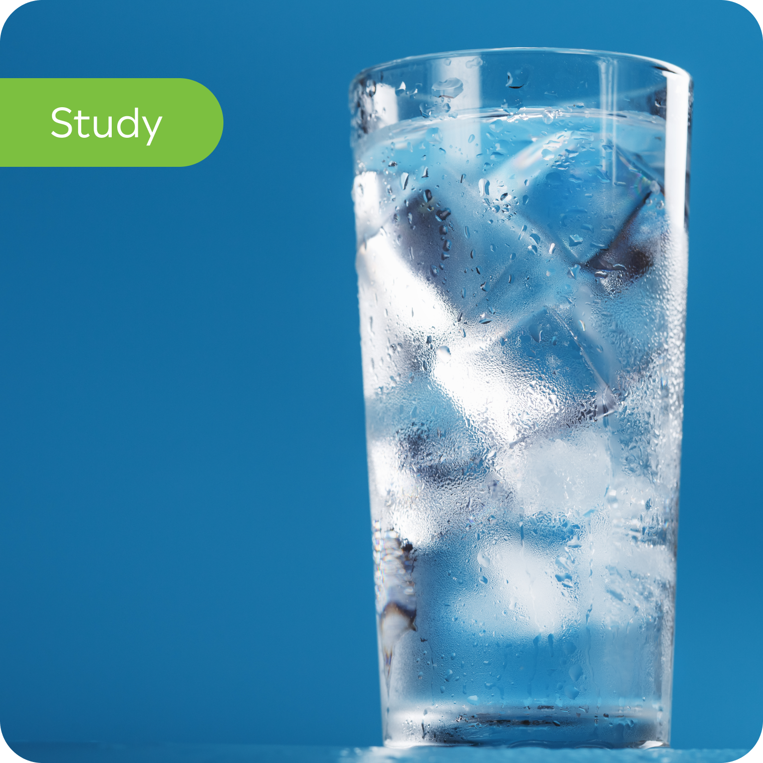 Glass of ice water with condensation, blue background, hydration study concept