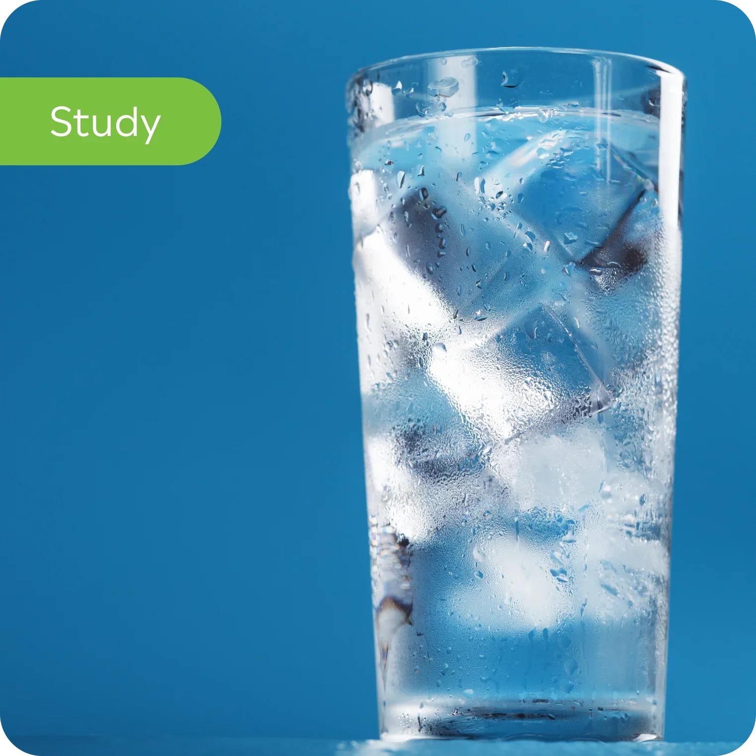 Glass of ice water with condensation, blue background, hydration study concept