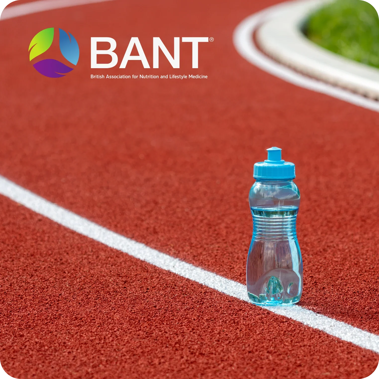 Sports water bottle on running track promoting hydration and electrolytes for athletes