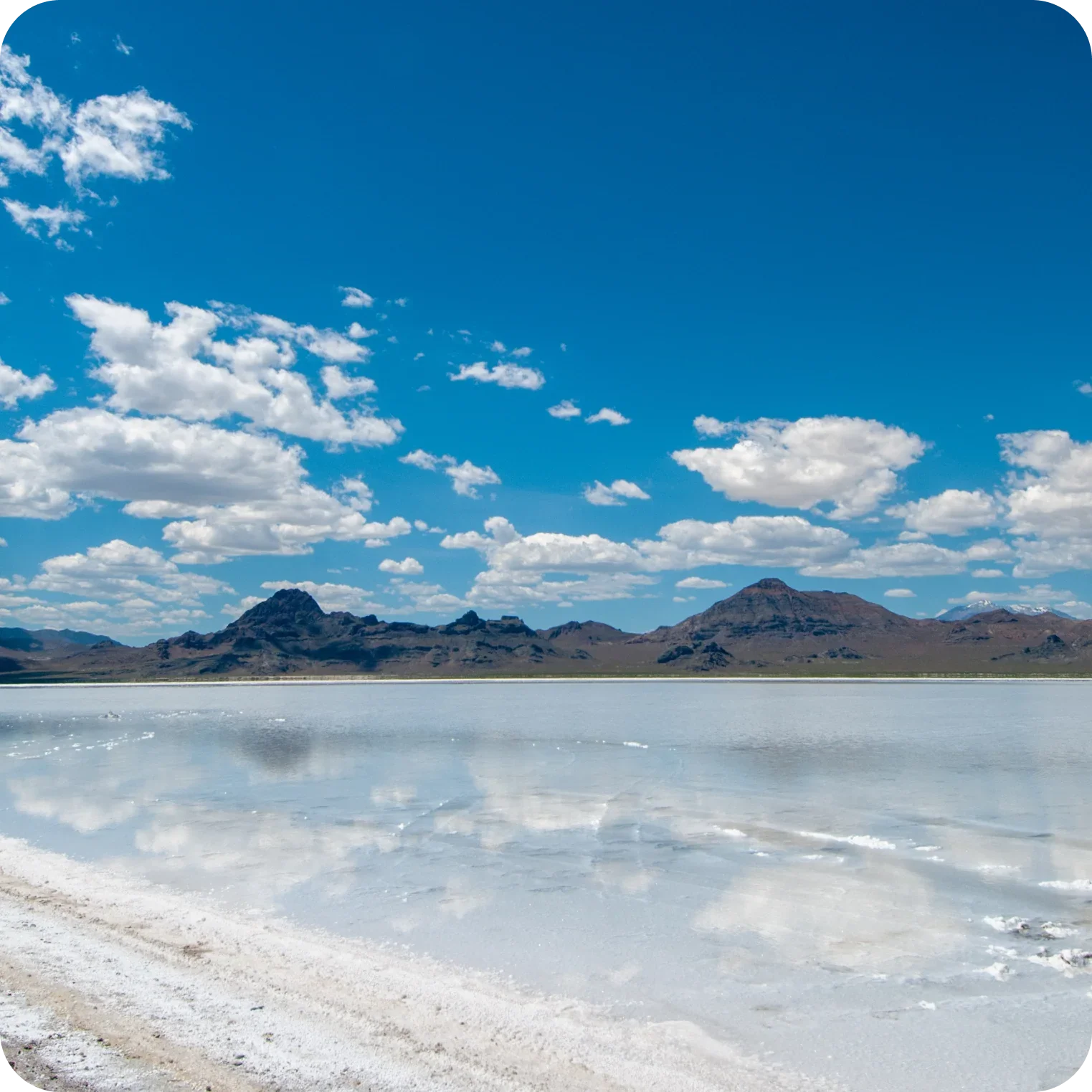 Natural salt flats with mountains and blue sky, source of natural electrolytes