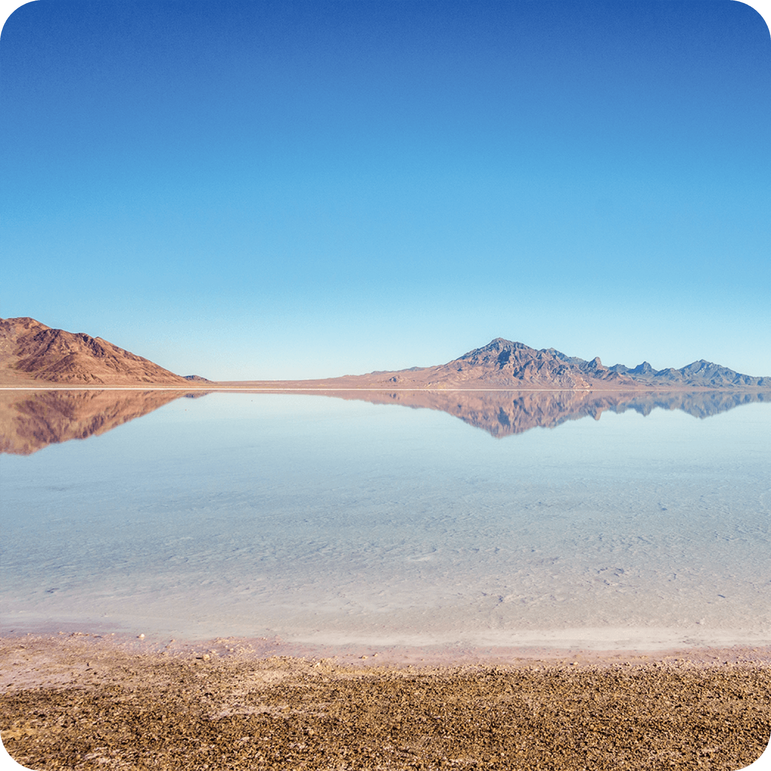 Natural salt flats landscape with clear water, mountains and blue sky, source of electrolytes