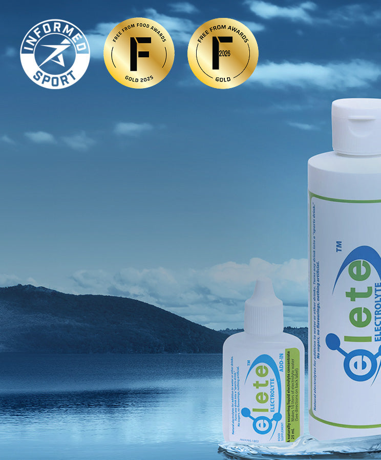 Two bottles of Elete Electronte product displayed against a scenic lake and mountain background, with Informed Sport award badges shown at the top left.